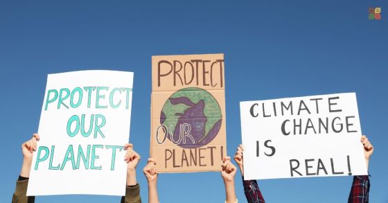 Young people holding protest signs about protecting the planet and climate change, representing generational concern about the future.