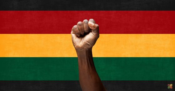 Raised Black fist in front of Pan-African flag colors for Juneteenth.